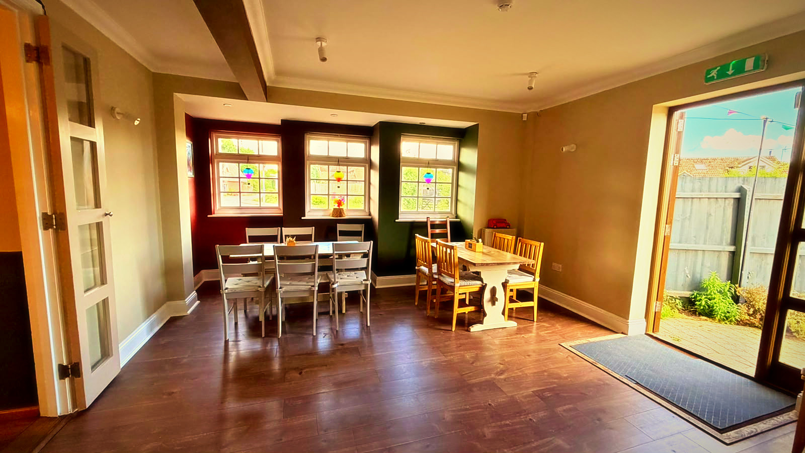 The sunlit garden room with doors to the courtyard at The Shepherd & Dog